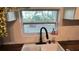 Kitchen sink with a modern faucet and a view of the backyard at 214 N New Hampshire Ave, Tavares, FL 32778