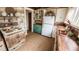 Rustic kitchen with wood walls, custom cabinets, a white refrigerator, and copper sink at 214 N New Hampshire Ave, Tavares, FL 32778