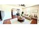 Well-lit living room with hardwood floors, modern furniture, and a view into the dining area at 214 N New Hampshire Ave, Tavares, FL 32778