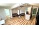 Open-concept living room featuring hardwood floors and white walls at 214 N New Hampshire Ave, Tavares, FL 32778