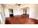 Spacious living room with hardwood floors, ceiling fan, and natural light at 214 N New Hampshire Ave, Tavares, FL 32778