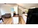 Open-concept room with wood floors, a couch, and kitchenette at 214 N New Hampshire Ave, Tavares, FL 32778