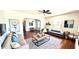 Open-concept living room featuring modern decor, hardwood floors, and a comfortable seating area at 214 N New Hampshire Ave, Tavares, FL 32778