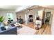 Open-concept living space with hardwood floors, a modern couch, and dining area at 214 N New Hampshire Ave, Tavares, FL 32778