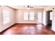 Living room with lots of windows, hardwood floors, ceiling fan, and bright natural light at 214 N New Hampshire Ave, Tavares, FL 32778