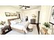 Comfortable bedroom featuring a bed, minimalist art, and a neutral color scheme at 214 N New Hampshire Ave, Tavares, FL 32778