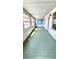 Screened porch with painted floors offering a tranquil and airy space at 214 N New Hampshire Ave, Tavares, FL 32778
