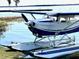 Blue and white seaplane on a lakefront dock at 214 N New Hampshire Ave, Tavares, FL 32778