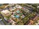 Expansive community resort-style pool and clubhouse amidst lush greenery, volleyball, and ample parking at 2153 Calabria Ave, Davenport, FL 33897