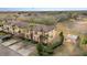 Aerial view of a neighborhood, with manicured lawns, towering trees, and community seating with a sun shade at 2153 Calabria Ave, Davenport, FL 33897