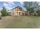 Townhome backyard featuring a well-maintained lawn, a private balcony, and access to outdoor amenities at 2153 Calabria Ave, Davenport, FL 33897