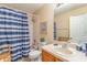 Bathroom showcases a shower-tub combo and vanity, creating a functional and pleasant space at 2153 Calabria Ave, Davenport, FL 33897