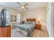 Bedroom with a ceiling fan, wood floor, and a side table with a lamp at 2153 Calabria Ave, Davenport, FL 33897