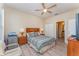 Bedroom with a ceiling fan, wood floor, and a view into the bathroom at 2153 Calabria Ave, Davenport, FL 33897