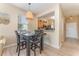 Dining area with a woven pendant light fixture, open to kitchen, and hardwood floors at 2153 Calabria Ave, Davenport, FL 33897