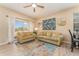 Cozy living room featuring neutral walls, hardwood floors, and a large window overlooking the neighborhood at 2153 Calabria Ave, Davenport, FL 33897