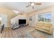 Bright living room with hardwood floors, a large window, and a stylish ceiling fan at 2153 Calabria Ave, Davenport, FL 33897