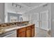 Well-lit kitchen featuring an island sink, granite counters, and open layout to living area at 2200 San Vittorino Cir # 104, Kissimmee, FL 34741