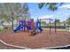 Colorful community playground with multiple slides, climbing structures, and safety-focused ground cover at 2200 San Vittorino Cir # 104, Kissimmee, FL 34741