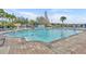 Large community swimming pool surrounded by lounge chairs, palm trees, and well-maintained landscaping at 2200 San Vittorino Cir # 104, Kissimmee, FL 34741