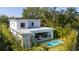 Aerial view of modern home featuring a backyard pool, patio with seating, and lush landscaping at 2412 Chantilly Ave, Winter Park, FL 32789