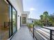 Outdoor balcony with railings and view of palm trees, accessible from a sliding glass door at 2412 Chantilly Ave, Winter Park, FL 32789