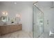 Bright bathroom featuring a double vanity, modern lighting, and a glass-enclosed shower at 2412 Chantilly Ave, Winter Park, FL 32789