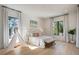 Bright bedroom with large windows, hardwood floors, and a stylish decor at 2412 Chantilly Ave, Winter Park, FL 32789