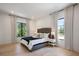 Bedroom with hardwood floors, natural light from large windows, and elegant decor at 2412 Chantilly Ave, Winter Park, FL 32789