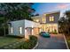 Stunning modern two-story home with a gravel driveway, two-car garage, and manicured landscaping at 2412 Chantilly Ave, Winter Park, FL 32789
