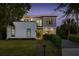 A modern two-story home exterior, beautifully landscaped with a well-manicured lawn and stylish design elements at 2412 Chantilly Ave, Winter Park, FL 32789