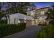 Stunning two-story modern home with a two-car garage, gravel driveway, and manicured landscaping at 2412 Chantilly Ave, Winter Park, FL 32789