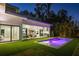 Modern exterior featuring backyard pool, outdoor kitchen, and covered seating area at 2412 Chantilly Ave, Winter Park, FL 32789