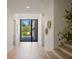 Bright foyer with wood floors, modern light fixtures, and views to backyard at 2412 Chantilly Ave, Winter Park, FL 32789