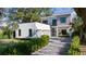 Modern two-story home features a gravel driveway, two-car garage, and manicured landscaping at 2412 Chantilly Ave, Winter Park, FL 32789