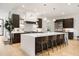 Modern kitchen with white countertops, dark wood cabinets, pendant lighting, and stainless steel appliances at 2412 Chantilly Ave, Winter Park, FL 32789