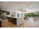 Bright, open kitchen boasts an island, modern appliances, and seamless flow to the living spaces and outdoor views at 2412 Chantilly Ave, Winter Park, FL 32789