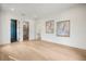 Living room with hardwood floors and views into bathroom and walk-in closet at 2412 Chantilly Ave, Winter Park, FL 32789