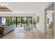 Open-concept living room featuring a dining area, modern furnishings, and expansive sliding glass doors to the backyard pool at 2412 Chantilly Ave, Winter Park, FL 32789