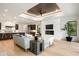 Open-concept living room with hardwood floors, fireplace, and connection to the kitchen at 2412 Chantilly Ave, Winter Park, FL 32789
