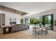 Stylish living room with a fireplace, modern decor, and sliding doors providing views and access to the backyard pool area at 2412 Chantilly Ave, Winter Park, FL 32789