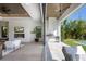 Bright living room features a fireplace, light wood floors and seamless transition to the outdoor kitchen and yard at 2412 Chantilly Ave, Winter Park, FL 32789