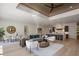 Open-concept living room with modern décor, wood-paneled ceiling, and seamless flow to the kitchen at 2412 Chantilly Ave, Winter Park, FL 32789