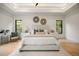 Bright, stylish bedroom with tray ceilings, wood floors, and a large upholstered headboard at 2412 Chantilly Ave, Winter Park, FL 32789