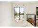 Stairway with modern chandelier and scenic views through black framed windows at 2412 Chantilly Ave, Winter Park, FL 32789