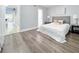 Comfortable bedroom with hardwood floors, neutral colors, and a stylish upholstered headboard at 262 Orienta Point St # 1, Altamonte Springs, FL 32701