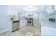 Modern kitchen features white cabinets, stainless steel appliances, and tile flooring at 262 Orienta Point St # 1, Altamonte Springs, FL 32701