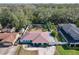 Aerial view of the waterfront property featuring a metal roof, fenced yard, and proximity to the water at 27622 Lois Dr, Tavares, FL 32778