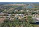 Aerial view of a property with a nearby lake and plant Bedroom at 27622 Lois Dr, Tavares, FL 32778