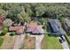 A waterfront home, enhanced by an aerial view highlighting its prime location, neat landscaping, and proximity to the water at 27622 Lois Dr, Tavares, FL 32778